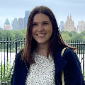 Woman stands in front of skyline