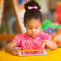 BIPOC child uses Ipad